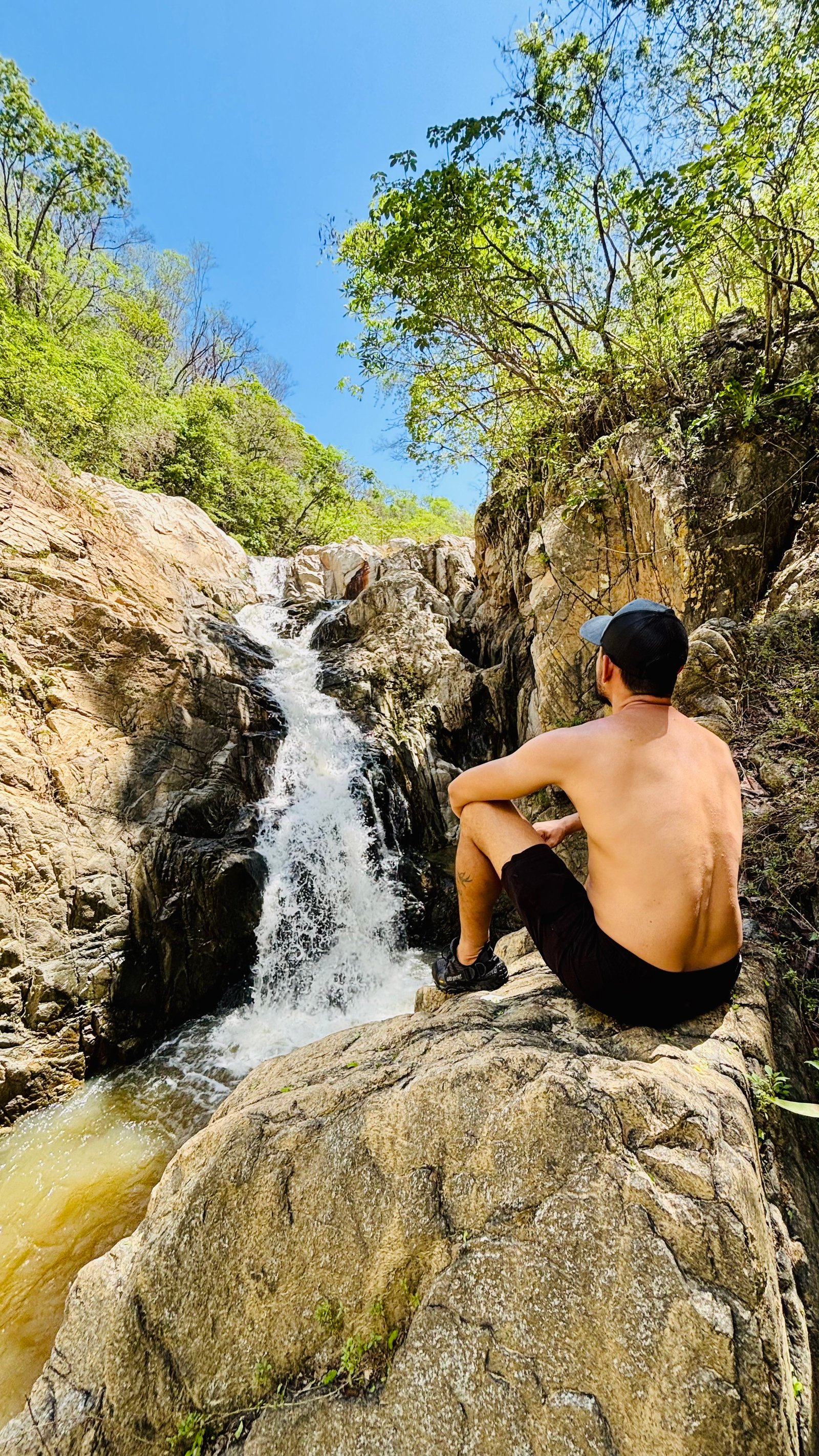 Man in contemplation by waterfall